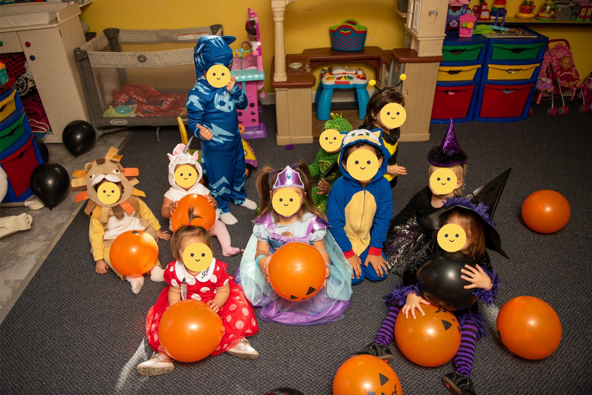 Children in halloween costumes playing with balloons.